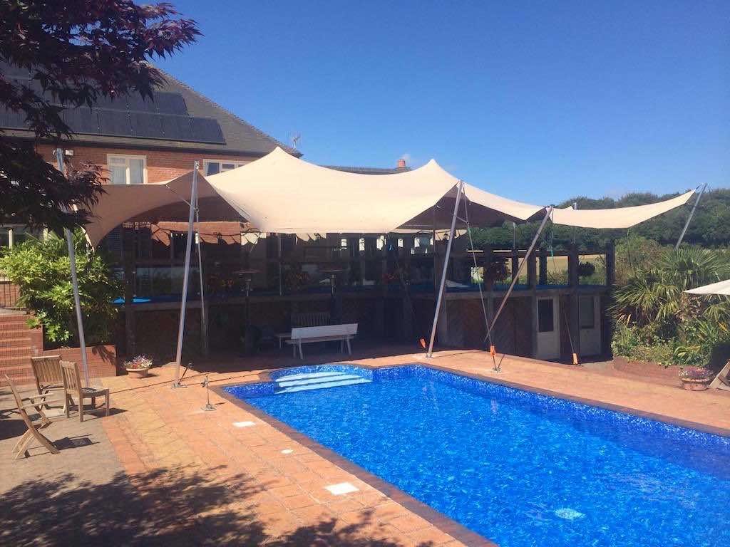 stretch tent installed over balcony and pool area