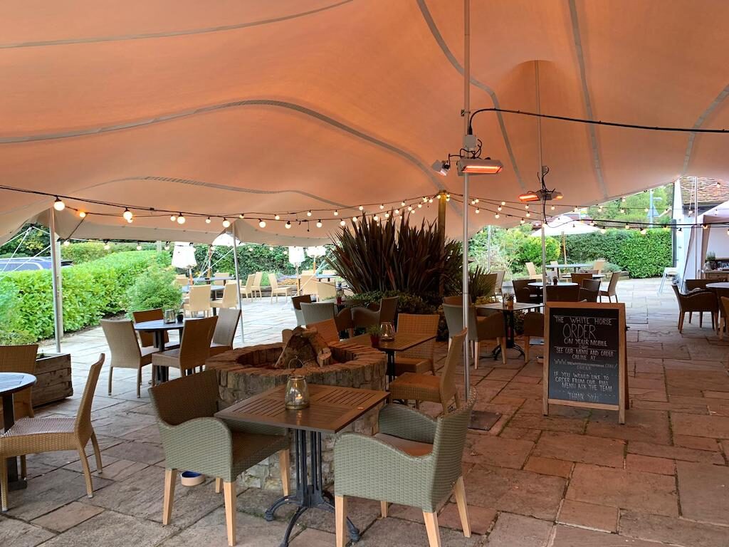 White horse pub use stretch tents for outdoor cover