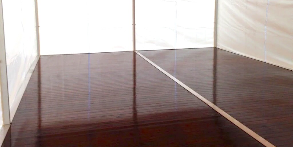 Integrated steel frame wooden floor set in Clearspan pavillion