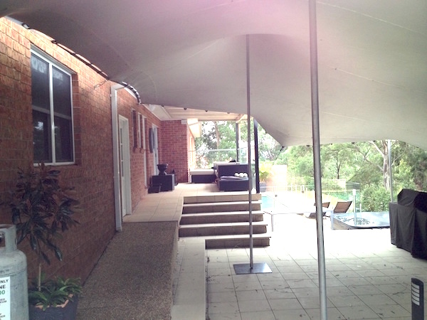 Stretch Tent attached to brick wall